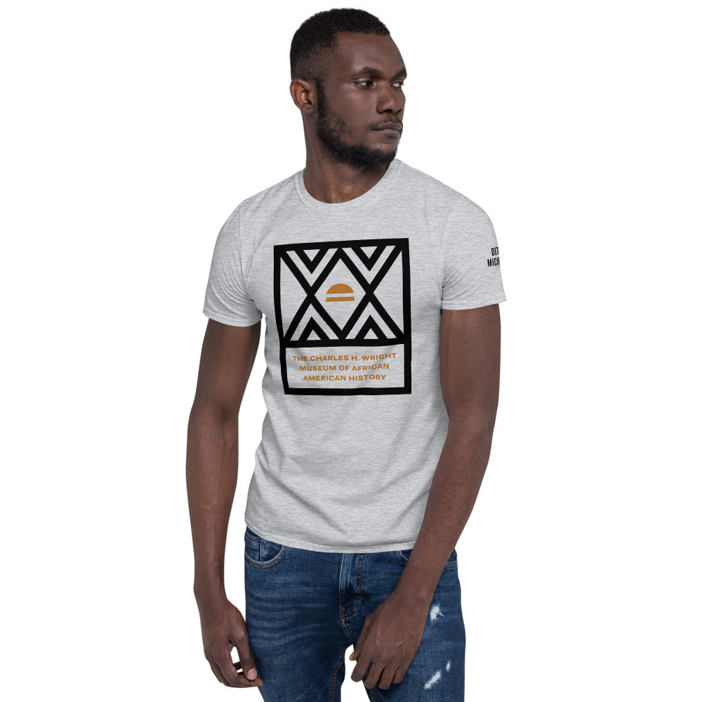 African American man wearing logo of the Charles H. Wright Museum emblazoned , in black, on the front of a light gray, cotton t-shirt.