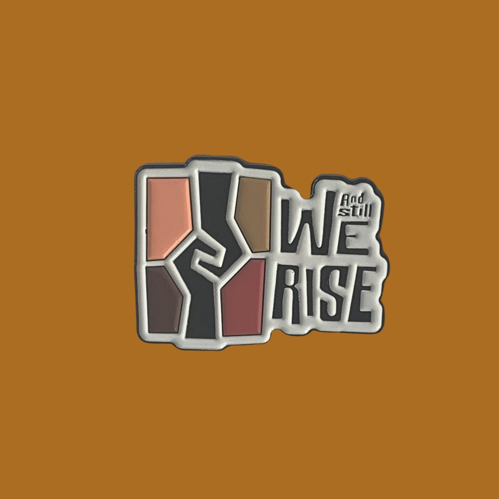 1.25 inch soft enamel lapel pin with the Ad Still We rise exhibition logo.