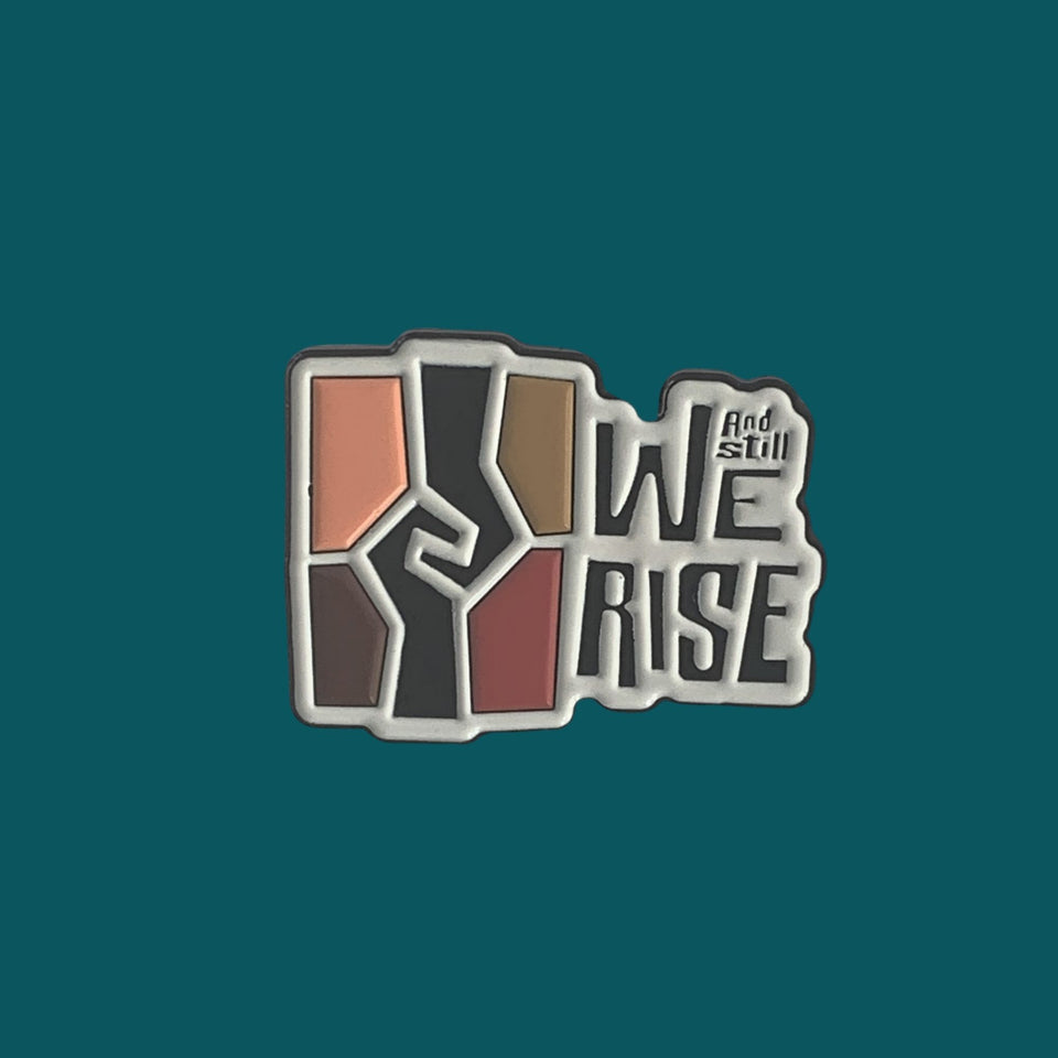 1.25 inch soft enamel lapel pin with the Ad Still We rise exhibition logo.
