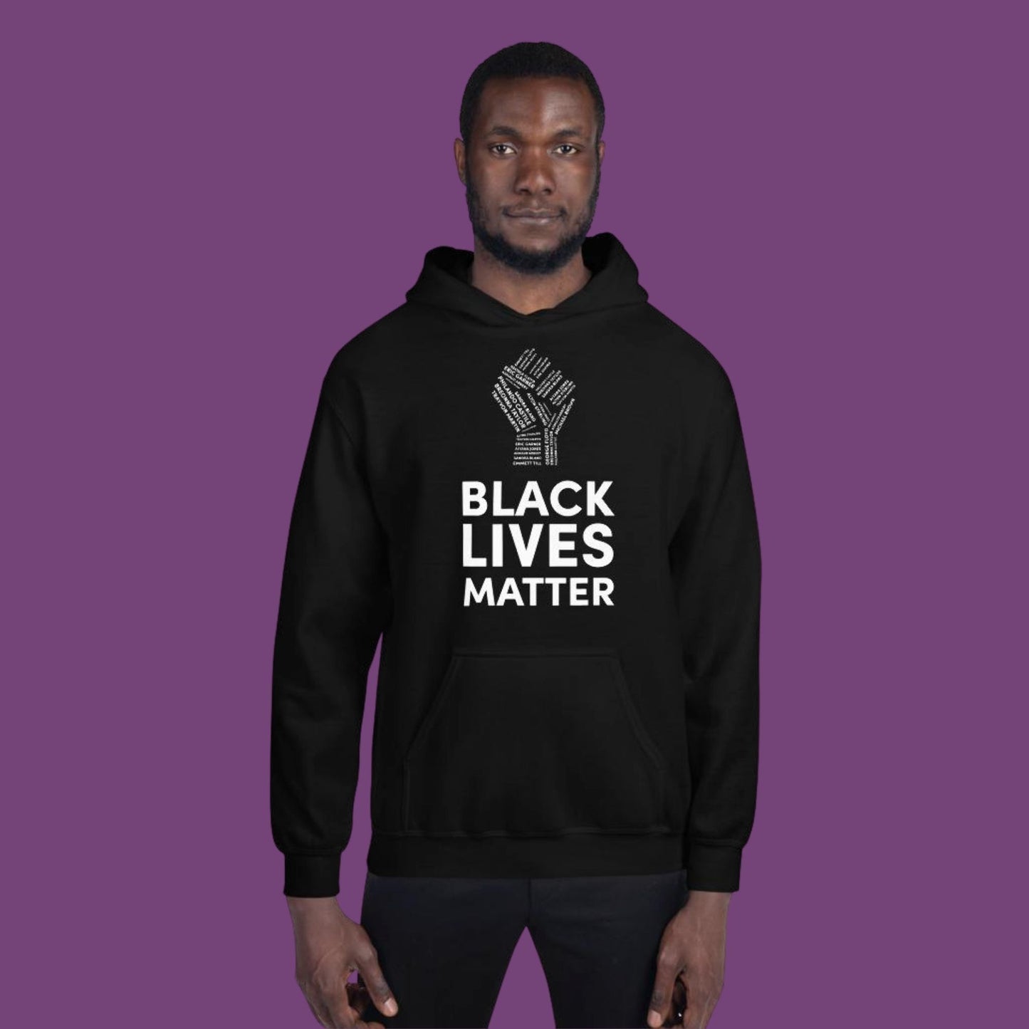 African American man wearing ablack hoodie with black lives matter in white with a white fist above